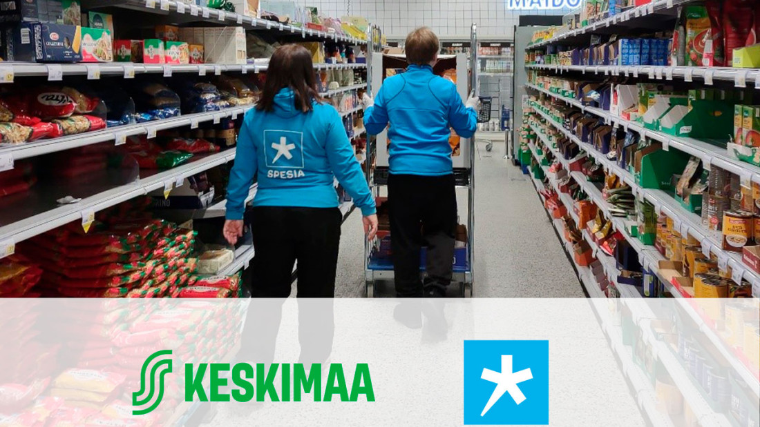 Poika työntää rullakkoa kaupan hyllyjen välissä ja nainen kulkee takana, kuvan etulalalla Keskimaan ja Spesian logot.