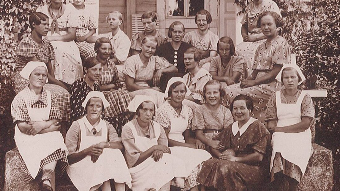Group picture of women on a porch outside.