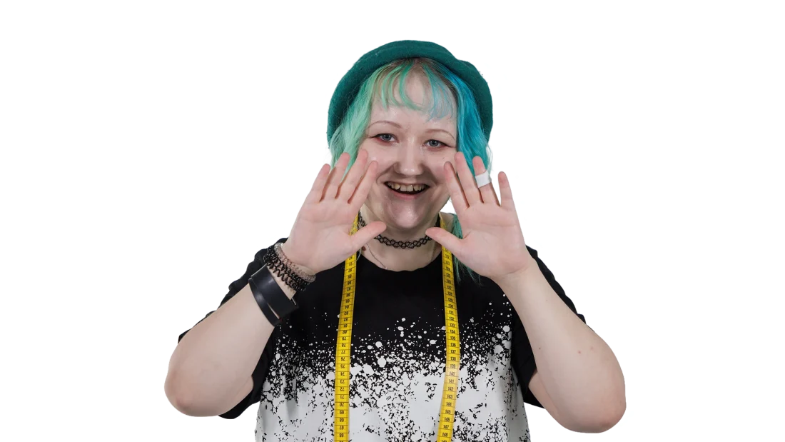 nuori opiskelija hymyilee kohti kameraa ja pitää käsiään kasvojen edessä kuvastaen asiaansa.