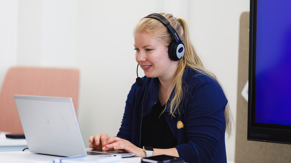 Suvi käyttää läppäriä luurit päässä.